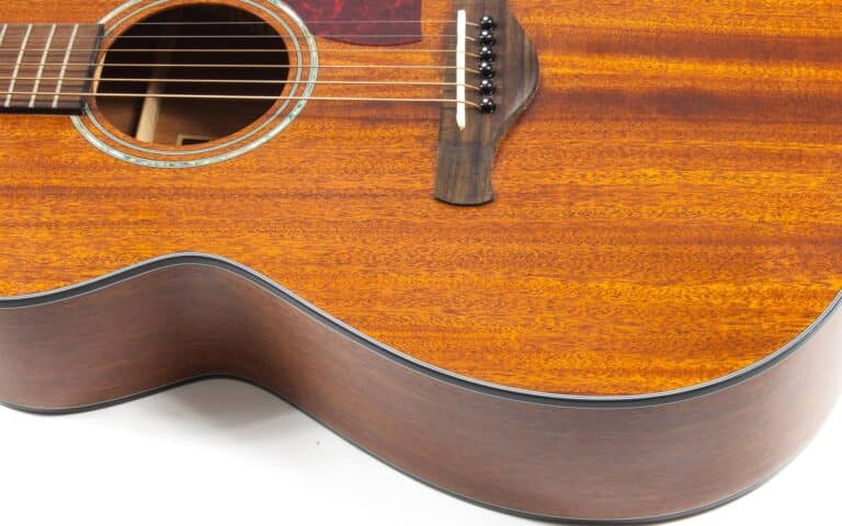 Best wood for acoustic guitar_cropped image of an acoustic guitar