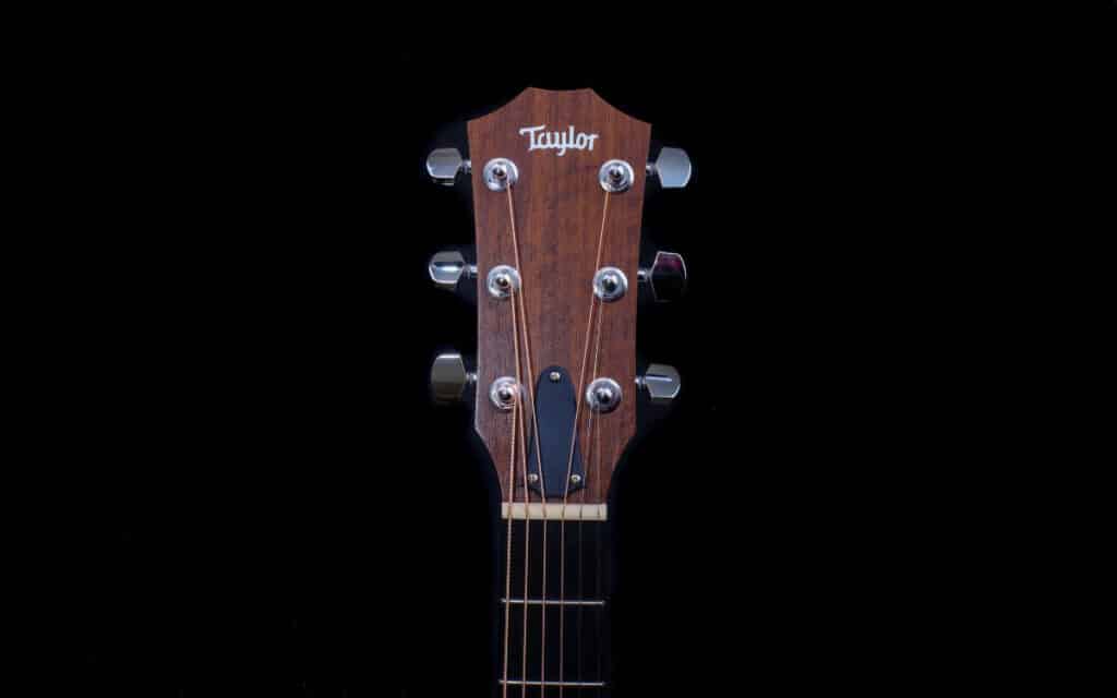 Taylor guitar headstock on black background