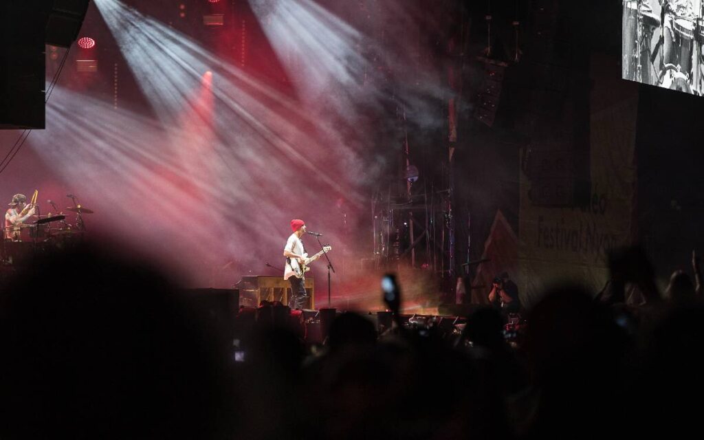 Tyler joseph playing guitar on stage