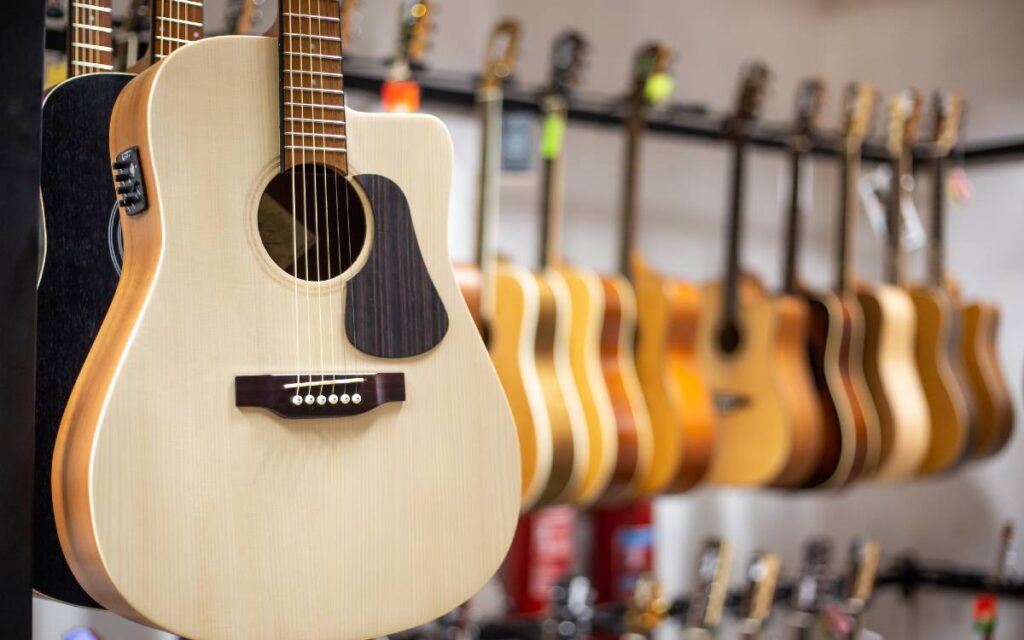 Acoustic guitars hanging in a music store