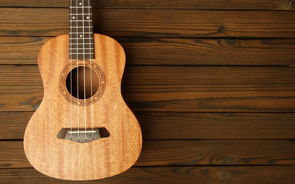 How much does a ukulele cost? Ukulele on wooden background
