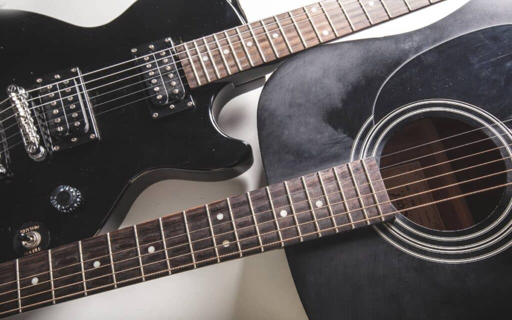 Acoustic and electric guitars on white background