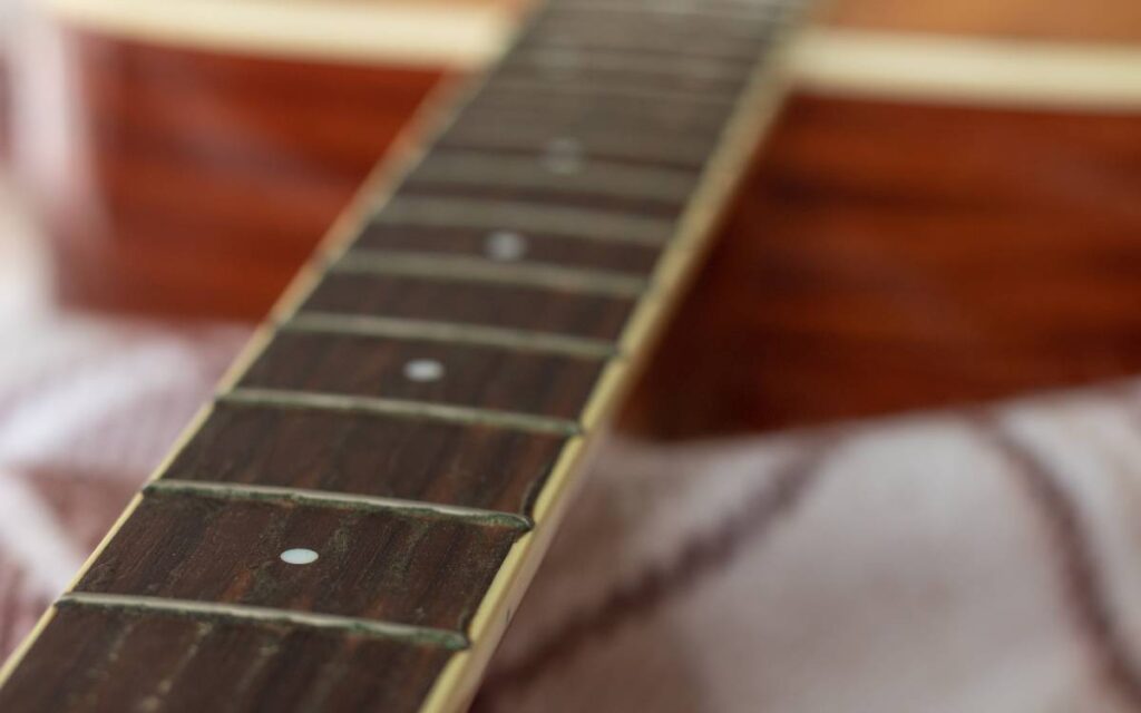 Guitar frets on acoustic guitar neck without strings