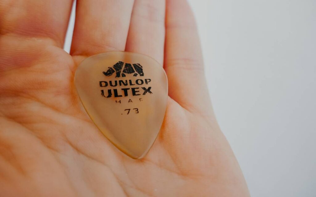 Guitar pick on man's hand