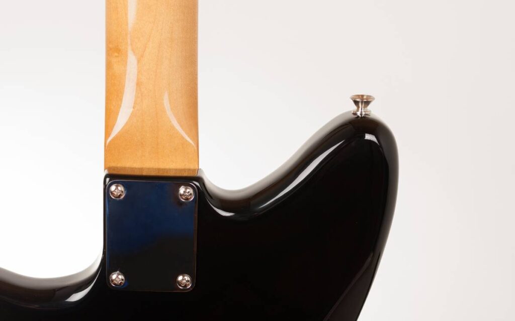 Cropped back view of electric guitar neck and body