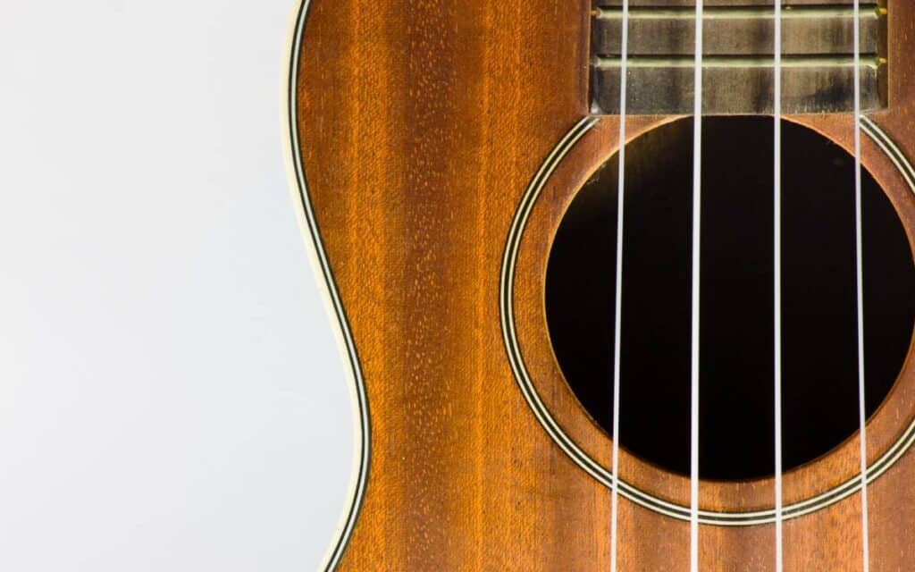 Close-up shot of a brown budget ukulele on white background